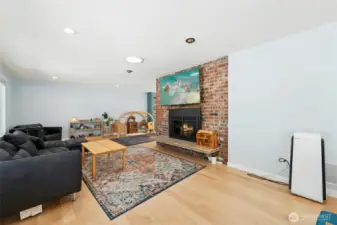 The hardwoods, big windows, tall ceilings, and brick fireplace feel like home.