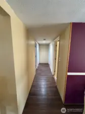 Hallway to 3 bedrooms & bathroom