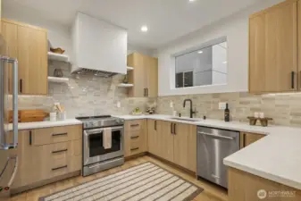 Stunning kitchen with upgraded Kitchen Aid appliance package, built in microwave, quartz countertops, hand-made tile and custom vent hood.  DREAMY!!
