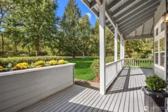 Charming wrap around porch offers another place to unwind and watch the squirrels at play