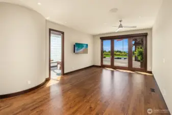 Main floor Primary with French doors to the back patio and spa pool