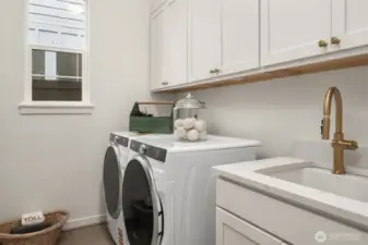 Laundry room includes cabinetry and washer and dryer