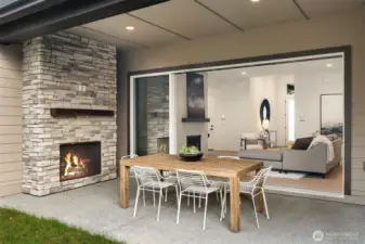 Multi-Slide Stacked doors open to covered patio with exterior fireplace