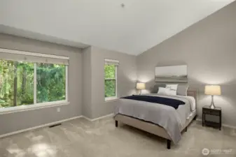 Spacious primary suite with views of the peaceful green space