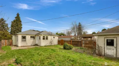 Detached garage has door within fenced back yard