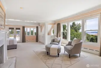 Primary suite complete with dual bathrooms and dual walk-in closets. Views of Mt. Rainier, Seattle skyline and Puget Sound. French doors lead to private view balcony with Porcelanosa tile.