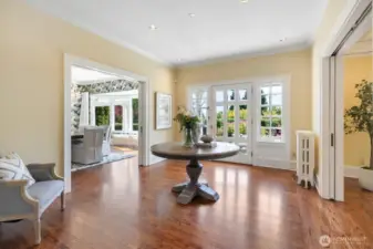 The original front door overlooks perfectly manicured verdant gardens and a private front porch