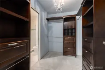 Primary bedroom has a walk in closet with custom shelving.