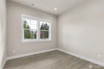 Flexible main-level room with large window, recessed lighting, and durable wide-plank flooring—ideal for a home office, guest room, or study. Neutral tones make it easy to personalize.