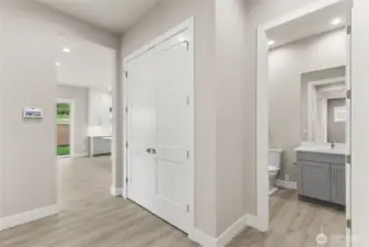 Main-level bedroom with neutral finishes, wide-plank flooring, and convenient access to an adjacent full bath. Ideal for guests, extended stays, or a private home office setup.