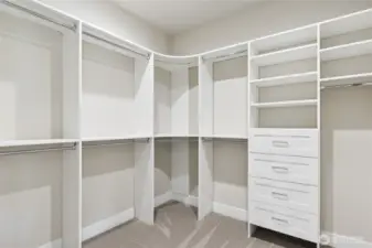 Spacious walk-in closet with custom built-in shelving, drawers, and double hanging rods—designed for maximum storage, organization, and convenience right off the primary suite.