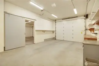 Oversized garage bay with shelving for storage, 10 ft door and opener.  Lots of lighting!