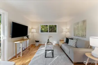 Adjacent to the eat-in kitchen, a versatile hangout area enjoys sliding doors to the patio and ample natural light.