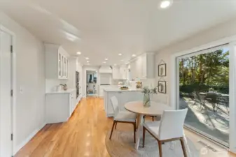 Updated kitchen features custom Bellmont cabinetry and generous storage, with a nearby garage door providing seamless grocery access.