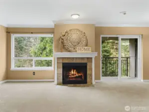 A warm & welcoming living space with wood-burning fireplace and brand-new carpet.