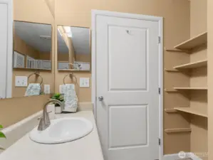 Additional storage shelves & linen space is available behind the bathroom door.