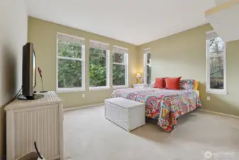 Cute cottage feel for the primary bedroom. And the big windows bring in light.