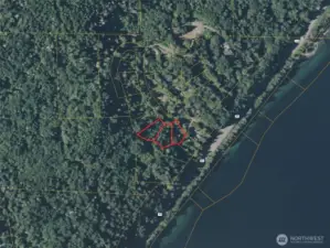 Approximate boundaries in red. Subject property is the middle lot. Neighboring lots for sale.