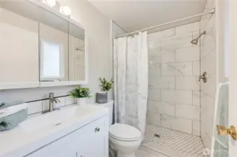Primary 3/4 Bathroom with New Vanity, New vinyl flooring and New Tiled shower