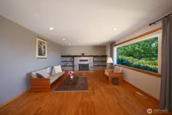 Living room with gas fireplace and large window to take in the view.