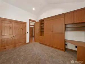 A versatile space designed for productivity and rest — custom wood cabinetry, built-in shelving, and a hidden Murphy bed make this an ideal office by day and private guest suite when needed. Access to its own patio creates seamless indoor-outdoor flow.