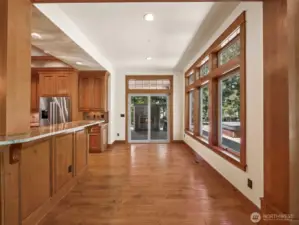 Bright and versatile dining nook located just off the kitchen offers panoramic backyard views, direct access to the covered patio and outdoor kitchen, and space for gatherings large or small.