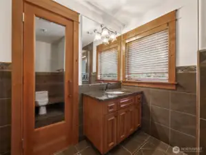 Your private wellness retreat includes a Finlandia dry sauna behind a glass door, paired with a beautifully tiled bathroom complete with granite vanity and ambient lighting — perfect for post-golf relaxation or cold therapy.
