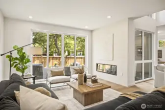 Gorgeous living room features electric fireplace feature, and double slider leading out to your private yard.  The perfect indoor/outdoor living