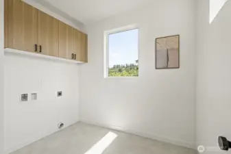 Spacious Laundry with built in cabinetry.  This is not just a laundry closet this is a vibe!