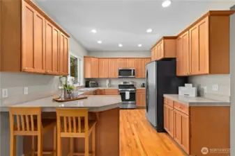 Well appointed chef's kitchen with granite counters and stainless steel appliances.