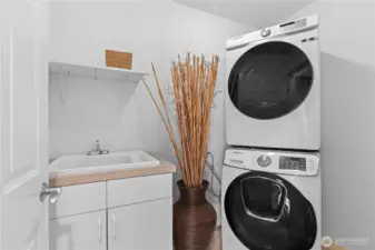 Upstairs laundry room with a sink.