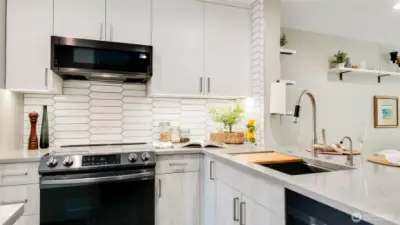 Kitchen with custom cabinets including under cabinet lighting