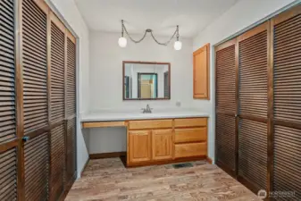 Attached dressing area, lots of closet space, vanity w/sink, medicine cabinet and great spot for a bench or hamper.