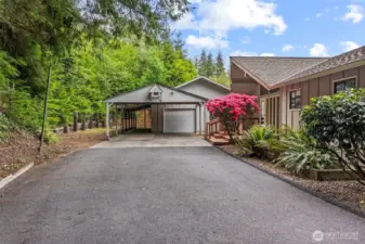 Concrete garage aprons surrounded by paved parking, detached and attached carports, single car garage w/guest space.