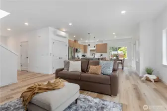 Great room showing double door to pantry closet, ductless heat pump and breakfast island with quartz top