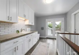 Laundry and mudroom with plenty of storage and a utility sink.