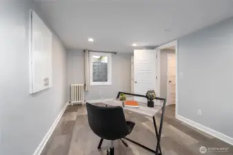 In the fully-finished basement, a 4th bedroom can also be used as a home office.  Lots of natural light through the oversized window.