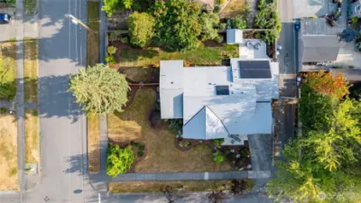 An overhead view of the home and property, camera facing south.  Backyard faces south, with excellent sun exposure for the solar panels.  New composition shingle roof in 2020.  Front of home faces Section Street, 12th Street is shown at left, with the alley just off the right side of the house.