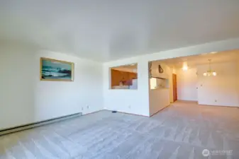 Living room with view of kitchen and dining area.