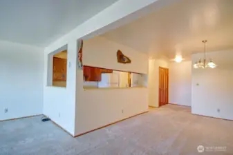 Closer view of kitchen, dining area and entry way.