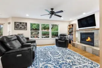 Living room with cozy gas fireplace with tiled mantel, (TV is included)
