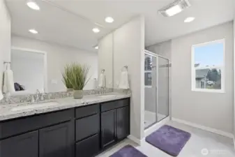 Primary bath with double sinks, tons of cabinet and drawer space and quartz counters.