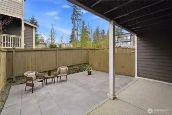 Generous paved patio, fully fenced, partially covered and perfect for relaxing, BBQs, gatherings!