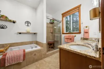 Ensuite bath with soaking tub, shower, pretty tile.