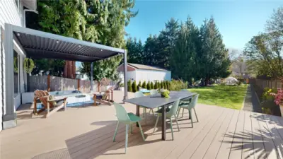 Expansive backyard designed for both entertaining and relaxation. A 600+ sq ft deck features a built-in hot tub, louvered pergola, and fire pit, while the lush yard offers garden beds, fruit trees, and a serene garden dome - your perfect cozy rainy-day retreat.