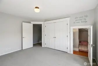 West facing bed showing closed closet doors and hide-away nook