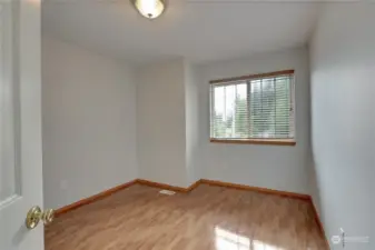 Second spare bedroom that also has a large windiw to let in light and beautiful hardwood floors.