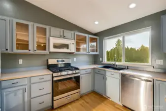 The kitchen is a dream for both everyday meals and hosting. Ample cabinets and generous counter space provide functionality without sacrificing style. Stainless steel appliances, including a gas range, make cooking a joy.