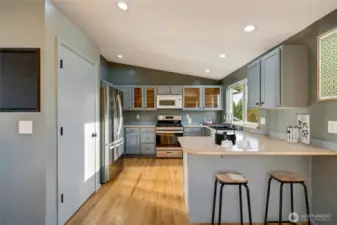 A breakfast bar connects seamlessly to the dining area, offering a casual spot for morning coffee or quick bites.