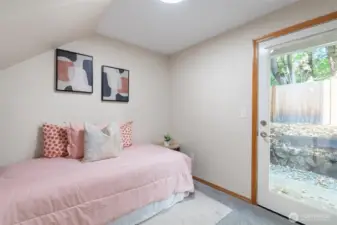 Downstairs bedroom with access to patio